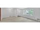 Bright living room featuring neutral carpet, white walls and a big window letting in plenty of natural light at 4856 Rock Haven Dr, Lilburn, GA 30047