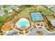 Overhead shot of community pool, tennis courts, and playground offering residents various recreational options and communal green spaces at 6915 Rambling Vale, Cumming, GA 30028