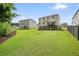 Spacious backyard featuring green grass, offering plenty of room for outdoor activities and relaxation at 6915 Rambling Vale, Cumming, GA 30028
