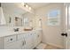Bright bathroom featuring dual sinks, white cabinetry and a large mirror offering a spa-like experience at 6915 Rambling Vale, Cumming, GA 30028