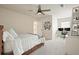 Bright bedroom with a ceiling fan, neutral carpet, and a cozy bed that offers a relaxing retreat at 6915 Rambling Vale, Cumming, GA 30028
