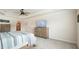 Large bedroom featuring wood furniture, neutral colors, and a view into the bathroom at 6915 Rambling Vale, Cumming, GA 30028