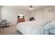 Inviting bedroom with a ceiling fan, plush carpet, and a scenic television creating a cozy retreat at 6915 Rambling Vale, Cumming, GA 30028