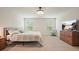 Comfortable bedroom with soft carpet, a ceiling fan, and a scenic television for entertainment at 6915 Rambling Vale, Cumming, GA 30028