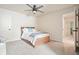 Cozy bedroom featuring a ceiling fan and a comfortable bed with wood frame, perfect for relaxation at 6915 Rambling Vale, Cumming, GA 30028