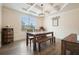 Dining room with hardwood floors, decorative ceiling, and large window at 6915 Rambling Vale, Cumming, GA 30028