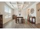 Dining room with hardwood floors, decorative ceiling, and large window at 6915 Rambling Vale, Cumming, GA 30028