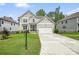 Charming two-story home with a two-car garage, manicured lawn, and stone accents at 6915 Rambling Vale, Cumming, GA 30028