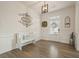 Bright foyer featuring hardwood floors, a decorative bench, and elegant wall decor at 6915 Rambling Vale, Cumming, GA 30028