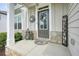Inviting front porch with decorative accents, a welcome sign, and stone accents at 6915 Rambling Vale, Cumming, GA 30028