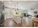 Open-concept kitchen and living room, with stainless steel appliances, seating and cozy fireplace at 6915 Rambling Vale, Cumming, GA 30028