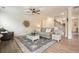 Bright living room with wood floors, comfortable seating, and a staircase at 6915 Rambling Vale, Cumming, GA 30028