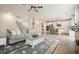 Open-concept living space with hardwood floors and seamless transition to the modern kitchen and dining area at 6915 Rambling Vale, Cumming, GA 30028