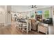 Open-concept living and kitchen area with seating and view of the fireplace at 6915 Rambling Vale, Cumming, GA 30028