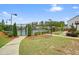 Well-maintained community tennis court with lighting and manicured landscaping at 6915 Rambling Vale, Cumming, GA 30028