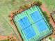 Overhead view of community tennis courts, showcasing well-maintained facilities for residents' recreational enjoyment at 6915 Rambling Vale, Cumming, GA 30028