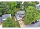 Aerial view of a home with a two-car garage, well-maintained lawn and mature trees in a suburban setting at 2640 Garland Way, Duluth, GA 30096