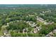 A neighborhood aerial view displays tree-lined streets and well-maintained homes in a suburban landscape at 2640 Garland Way, Duluth, GA 30096