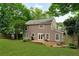 Expansive backyard featuring a lush lawn, mature trees, and a charming outdoor seating area at 2640 Garland Way, Duluth, GA 30096