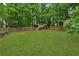 The backyard features a lush lawn and playground, providing ample space for outdoor fun and recreation at 2640 Garland Way, Duluth, GA 30096