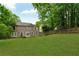 Expansive backyard with a well-maintained lawn, privacy fence, and view of the home's exterior at 2640 Garland Way, Duluth, GA 30096