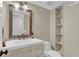 Updated half bathroom with white sink cabinet, and shelving unit on the right at 2640 Garland Way, Duluth, GA 30096