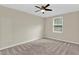 A bright and neutral bedroom with a light ceiling fan and a natural-colored carpet at 2640 Garland Way, Duluth, GA 30096