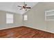 Bright bedroom with hardwood floors, a ceiling fan, and windows for natural light at 2640 Garland Way, Duluth, GA 30096