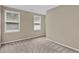 Bright bedroom with two windows offering lots of natural light and neutral-colored carpet at 2640 Garland Way, Duluth, GA 30096