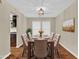 Traditional dining room featuring hardwood floors, neutral walls and a decorative light fixture at 2640 Garland Way, Duluth, GA 30096