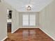 Dining room with hardwood floors, a stylish light fixture, and views of the kitchen and backyard at 2640 Garland Way, Duluth, GA 30096