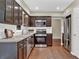 Modern kitchen featuring stainless steel appliances, granite countertops, and dark wood cabinetry at 2640 Garland Way, Duluth, GA 30096