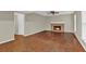 Cozy living room features hardwood floors, a ceiling fan, neutral paint, and a brick fireplace at 2640 Garland Way, Duluth, GA 30096