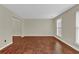 Spacious living room with gleaming hardwood floors, neutral walls, and bright natural light at 2640 Garland Way, Duluth, GA 30096