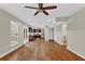 Bright, open living space with hardwood floors, a ceiling fan, backyard views, and connection to the kitchen at 2640 Garland Way, Duluth, GA 30096
