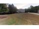 Charming brick home with a well-maintained lawn and mature trees providing shade and privacy at 4255 Ben Hill Rd, Atlanta, GA 30349