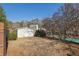 Backyard featuring a shed, some shrubbery and glimpses of the community pool, offering outdoor storage and recreation at 6027 Wintergreen Rd, Norcross, GA 30093