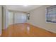 Spacious bedroom featuring hardwood floors, two closets, and a window with natural light at 6027 Wintergreen Rd, Norcross, GA 30093
