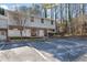 Inviting two-story townhouse with neutral siding, brick accents, and a convenient parking area for residents and visitors at 6027 Wintergreen Rd, Norcross, GA 30093
