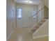 Welcoming foyer with tile flooring, natural light, and staircase leading to upper floors, creating a grand entrance at 6027 Wintergreen Rd, Norcross, GA 30093