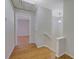 Hallway with hardwood floors, a white staircase, a modern light fixture, and access to a bedroom at 6027 Wintergreen Rd, Norcross, GA 30093