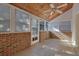 Well-lit sunroom with classic brick walls, tiled flooring, and a vaulted wood ceiling, perfect for relaxation at 6027 Wintergreen Rd, Norcross, GA 30093