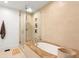 This bathroom features a glass shower with a built-in niche and an adjacent soaking tub at 845 Spring Nw St # 408, Atlanta, GA 30308