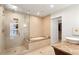 Bright bathroom featuring a glass shower, soaking tub, and a doorway to a walk-in closet at 845 Spring Nw St # 408, Atlanta, GA 30308