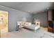 Well lit bedroom featuring plush carpeting, modern decor, and an ensuite bathroom at 845 Spring Nw St # 408, Atlanta, GA 30308