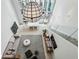 View of the living room with high ceilings, a modern light fixture and a glass-enclosed staircase at 845 Spring Nw St # 408, Atlanta, GA 30308