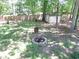 Backyard featuring a fire pit, shed, and a wooden fence, perfect for outdoor relaxation and entertainment at 1934 Mcconnell Rd, Grayson, GA 30017