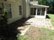 Spacious backyard featuring a screened-in patio and brick-paved area, perfect for outdoor gatherings and relaxation at 1934 Mcconnell Rd, Grayson, GA 30017
