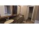 Bathroom with double vanity, granite countertops and a walk-in closet with wire shelving at 1934 Mcconnell Rd, Grayson, GA 30017