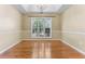 Dining room featuring hardwood flooring, tray ceiling, and a large window at 1934 Mcconnell Rd, Grayson, GA 30017